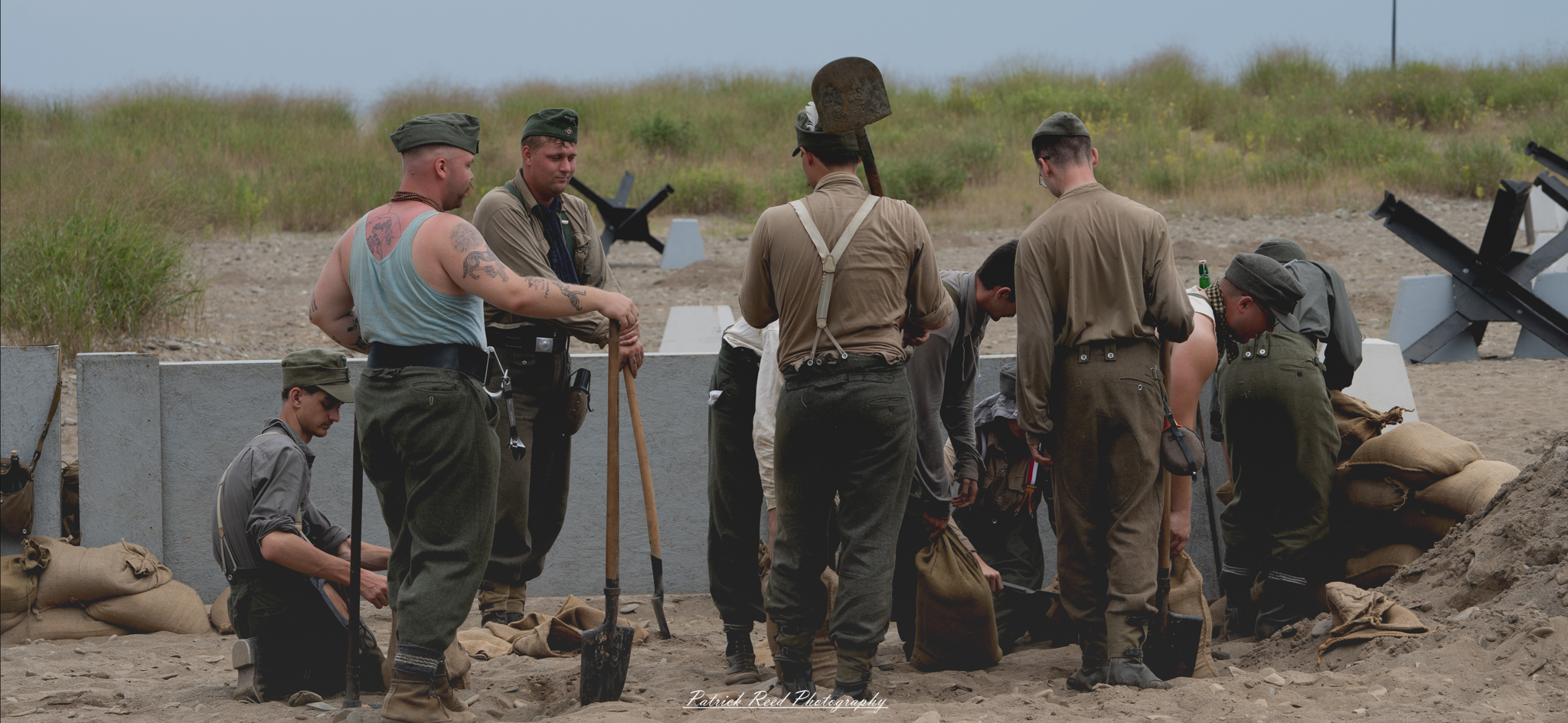 German soldiers actively digging fortifications, focused on their task as they excavate the earth to create protective barriers. The scene highlights the intensity of wartime preparation and the strategic efforts to enhance defensive positions on the battlefield.